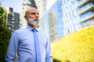 Confident businessman outdoors in urban setting