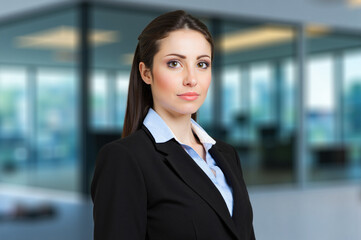 Confident businesswoman posing in modern office building