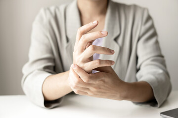 Woman hand with wrist pain numbness and pain in the palm of the hand has pain and tingling in the nerve endings This is a side effect of sitting and working for a long time on a laptop at the office