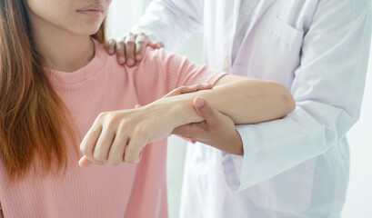 Female physiotherapists provide physical assistance to women patients with elbow injuries examine patients in rehabilitation centers. Physiotherapy concepts