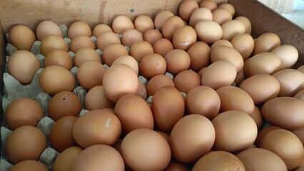Fresh eggs neatly arranged in wooden crates being sold in front of the shop