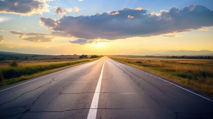 An empty road stretching into the horizon at sunset.