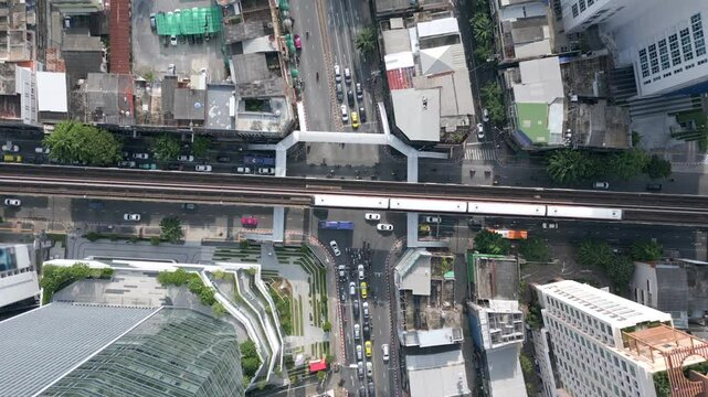 Aerial view of morning traffic at the intersection with the BTS Skytrain in downtown Bangkok, Thailand