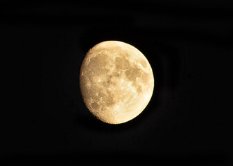 Yellow moon isolated on black background