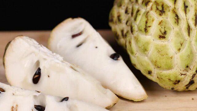Custard Apple Slices on Wooden Surface