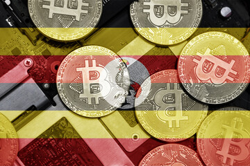 flag of uganda on the bitcoins with computer electronic circuit board background. bitcoin concept.