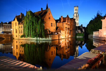 Fototapeta premium Old town of Bruges, Belgium. Bruges cityscape Dock of the Rosary (Rozenhoedkaai) and Belfort (belfry) tower and medieval houses at nigt, Bruges (Brugge), Belgium