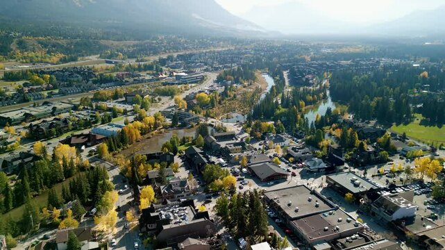 Aerial view of Town of Canmore downtown area in a autumn sunny day. Canadian Rockies mountain range in background. Alberta, Canada.