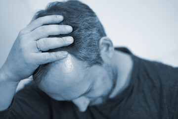 A regretful man tears his hair, worries