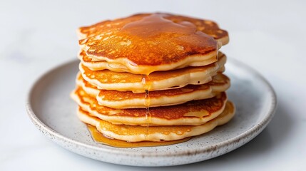 Stack of fluffy pancakes with honey drizzle