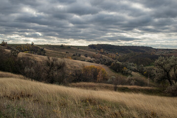 The hill overlooks the river, surrounded by yellow trees that seem to dip autumn into the water.