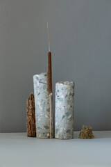 Abstract nature scene with composition of stones and dry branch. Neutral beige background for cosmetic, beauty product branding, identity and packaging. Natural pastel colors. Copy space, front view.