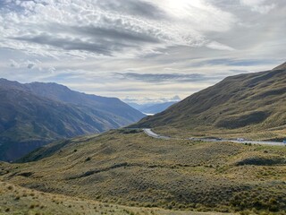 Obraz premium Scenic views at the Crown Range Summit Lookout . Landscape with mountains and clouds