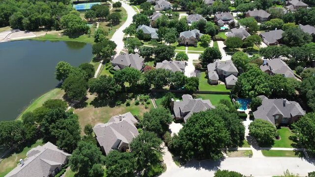Upscale lakeside residential area row of two-story single-family houses swimming pool in homeowner association neighborhood with tennis court in Keller, Texas, fast growing Dallas Fort Worth area