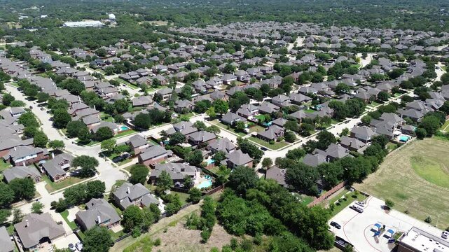 Master planned community row of upscale two-story single-family houses swimming pools in Keller, Texas, city water tower, lush greenery tree community near Dallas Fort Worth metroplex, flyover