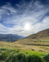 Naklejka premium Scenic views at the Crown Range Summit Lookout . Landscape with mountains and clouds