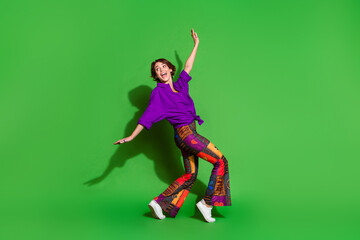 Photo of funny young girl in trendy outfit flying dreamer and brown bob haircut feeling freedom travel isolated on green color background