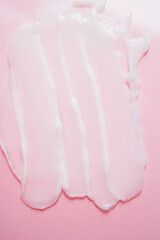 Sample of cosmetic cream on a pinkbackground. Texture of cosmetic skin care product