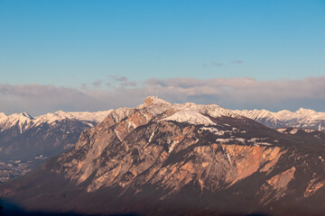 Breathtaking panoramic view of a snow-capped mountain peak Dobratsch seen from Karawanks, Carinthia, Austria. Twilight atmosphere. Natural beauty and peaceful tranquility in Austrian Alps in winter