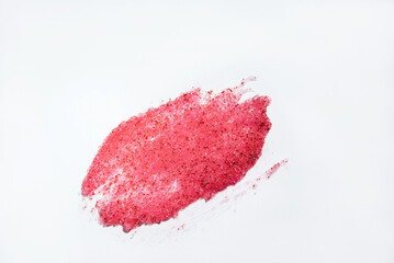 Close-up of a smear of a skin scrub on a white background. Texture of skin care cosmetic product. Cleansing and exfoliating your skin.