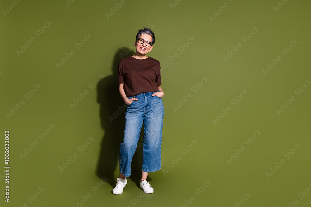 Wall mural Full size photo of nice aged woman empty space ad wear t-shirt isolated on khaki color background