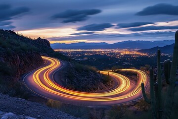 A vertical long exposure shot of a road in the mountains under a sunset sky