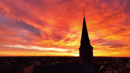 Stunning sunset view over a church steeple in the countryside at dusk - Powered by Adobe