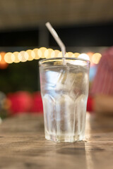 A glass of water with ice on a wooden table, clean water, drinking water