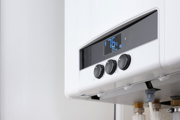 Close-up regulators a modern digital gas boiler. Setting the central heating level in a gas boiler.