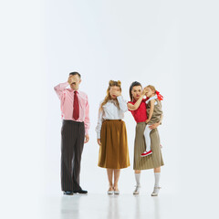 Three people, including young girl, covering their eyes in synchronized gestures, playing with the...