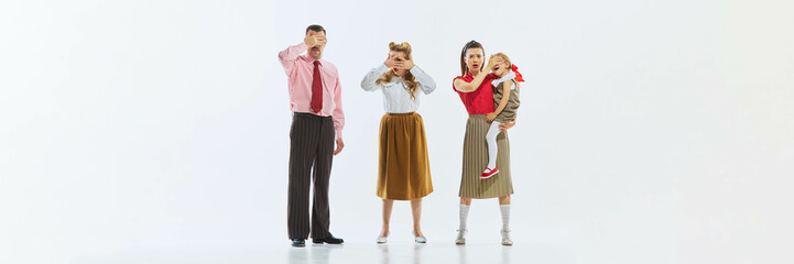 Three people, including young girl, covering their eyes in synchronized gestures, playing with the idea of ignoring or avoiding something. Concept of playful avoidance.