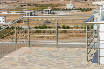 An Empty Terrace Overlooking Vast Arid Land With Modern Architecture in a Serene Landscape