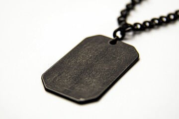 Fototapeta premium A black dog tag hangs from a chain, ready to be worn