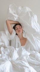 Woman in flowy white sheet appears to be in peace