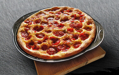 Focaccia with tomatoes and oregano in a pan