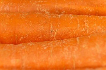 Close-up of a vibrant orange carrot with detailed texture, highlighting its fresh, natural surface....