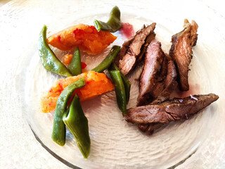 Plate with portion of pork pluma with cooked vegetables