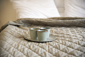 beige interior of bedroom with three blue cups. Beige tone. Coziness conception	