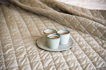 beige interior of bedroom with three blue cups. Beige tone. Coziness conception	