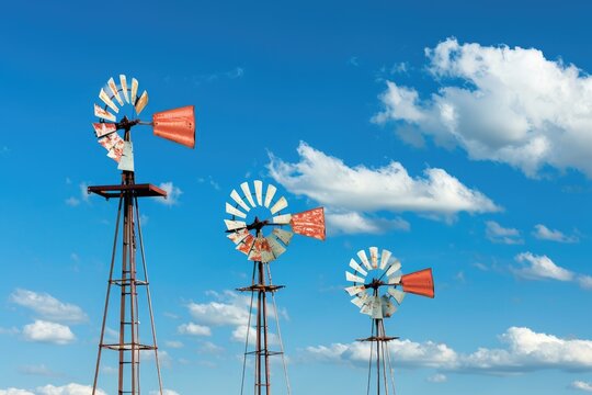 A group of windmills situated in a green field, great for backgrounds or landscape images