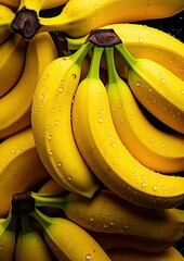 Freshly harvested yellow bananas with water droplets glistening under soft light in a dark background