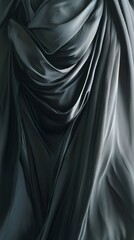 Fototapeta premium Smooth, luxurious dark green satin fabric is draped and flowing, forming elegant waves and folds. The light reflects off the fabric, creating a sense of movement and depth