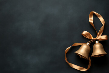 Two elegant gold bells with ribbons on a dark background. - Powered by Adobe