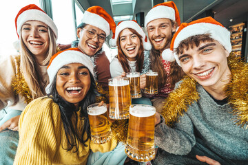 Happy friends wearing santa claus hat having Christmas dinner party- Cheerful young people sitting...