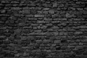 Old black brick wall tetxure. Grunge background