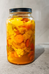 A vibrant and colorful jar filled with an assortment of pickled vegetables, ideal for salads and snacks alike.