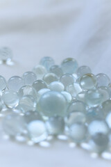 clear Glass marbles on a white background, close-up, selective focus