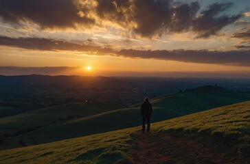 Fototapeta premium Silhouette of Person at Sunset - Dramatic Sky and Peaceful Evening Atmosphere
