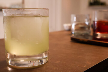 Refreshing Cocktail in a Glass with Ice on a Bar Counter