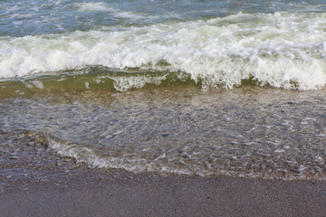 Close-Up of Ocean Wave Washing Over Sandy Beach